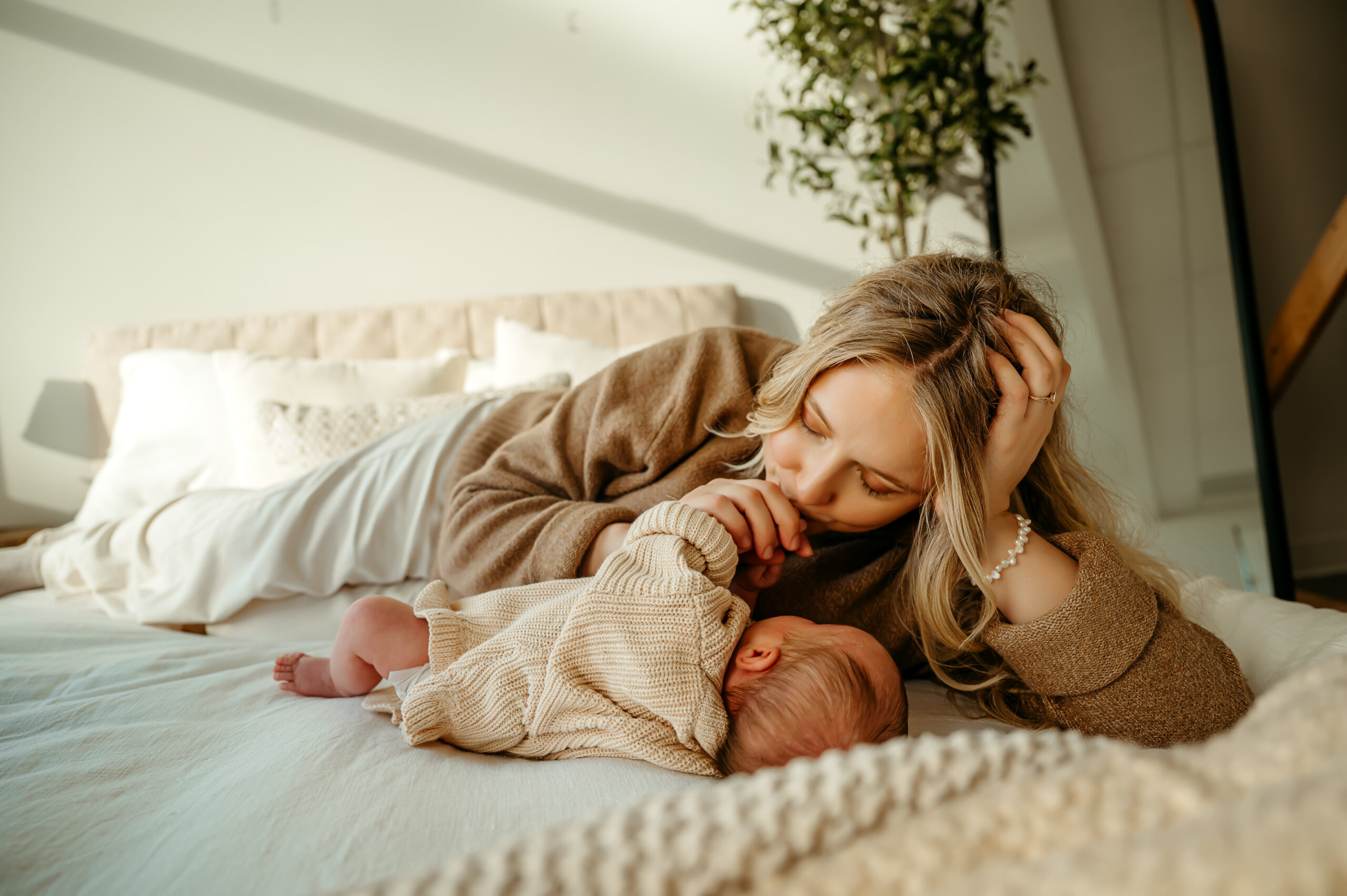 in between moment of parent kissing on newborn baby