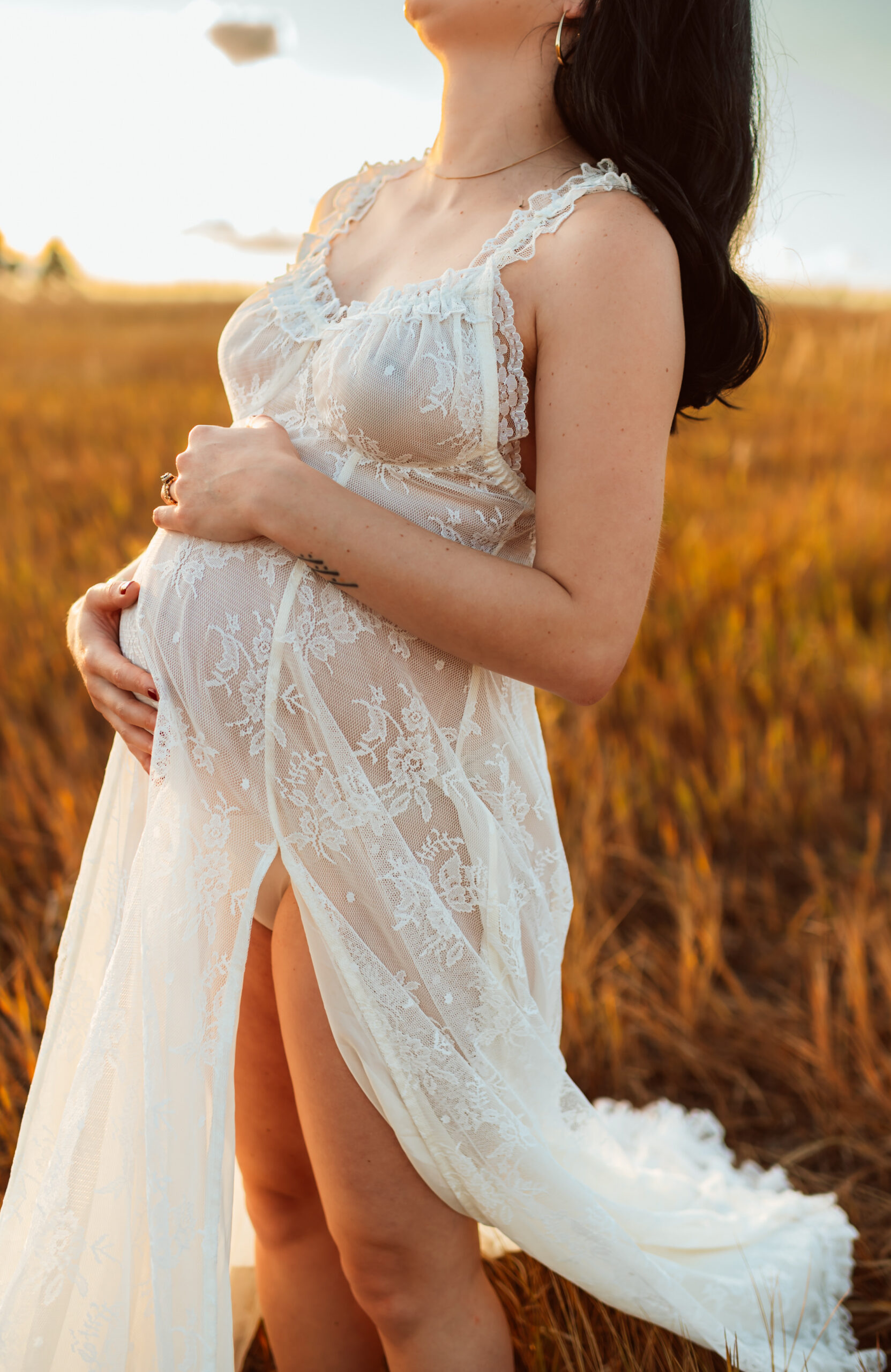 Pregnant woman in a flowing dress during a golden hour maternity photoshoot in Spokane.