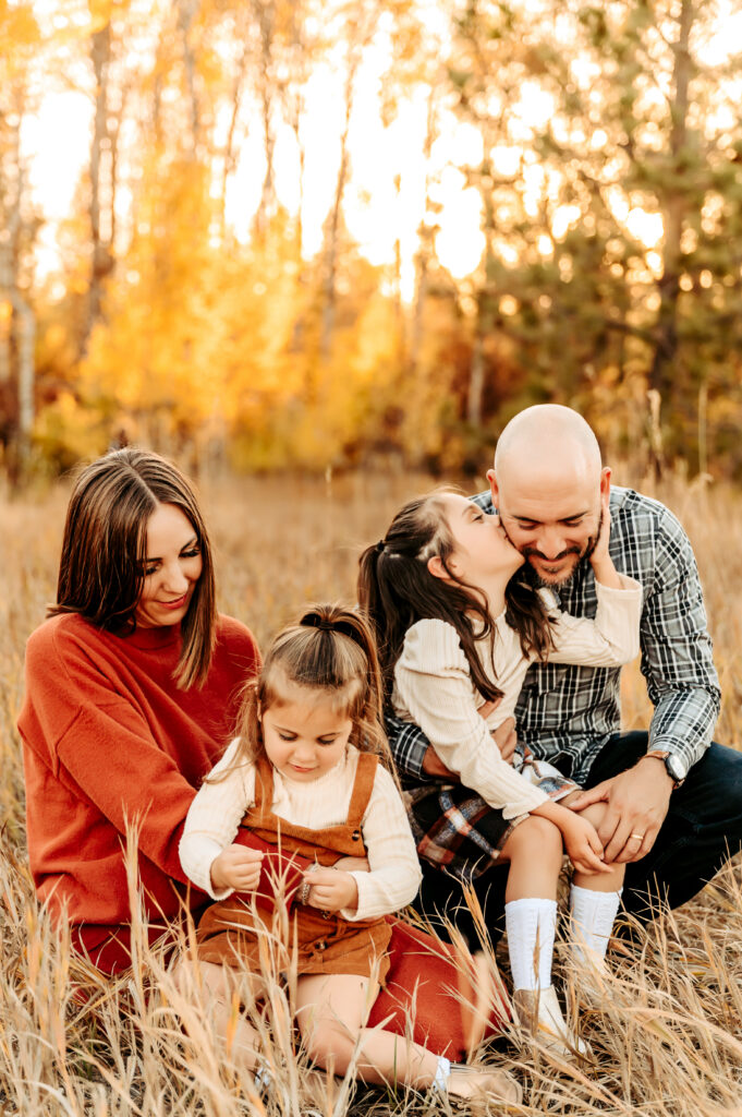 family cuddling during golden hour in the fall 