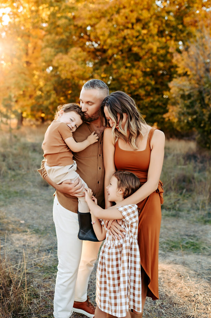 Spokane family cuddling in golden hour lighting 