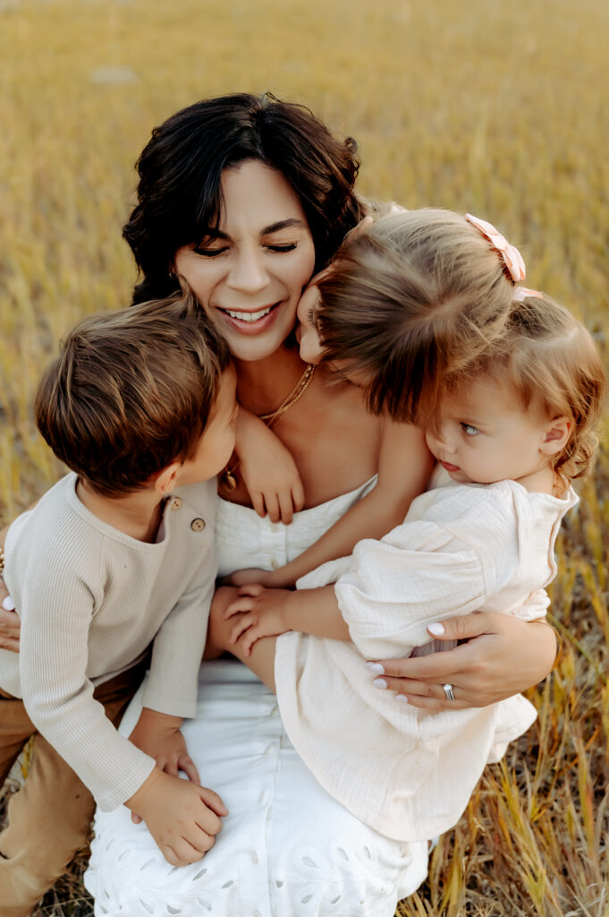 Candid family photo session with kids and parents laughing together outdoors- Jade Averill Photography Spokane
